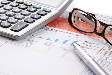 Image showing Stock chart with calculator,pen and eyeglasses 