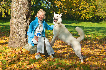 Image showing The woman with a dog in autumn park