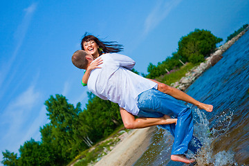 Image showing Enamored couple embracing on sunny beach