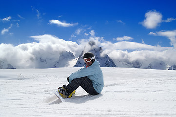 Image showing Snowboarder resting on the ski slope