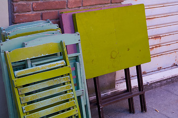 Image showing Tables and stairs with different colors on a wall