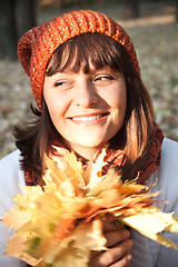 Image showing woman with autumn orange leaves