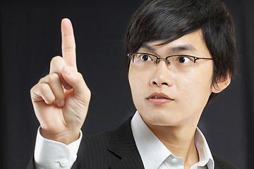 Image showing young business man in a suit pointing with his finger