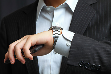 Image showing men's hand with a watch. 