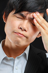 Image showing Tired business man holding his head