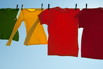 Image showing Bright multi-colored clothes drying in the wind