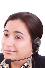 Image showing Young beautiful girl in headset,sitting at the desk tired, isola