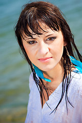 Image showing Portrait of beautiful brunette girl with wet hair near blue sea