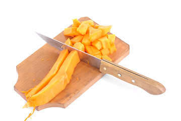 Image showing Slices of pumpkin and cutting board and knife , isolated on white background 