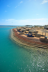 Image showing Wicker Beach Umbrella with wicker wind breaks.