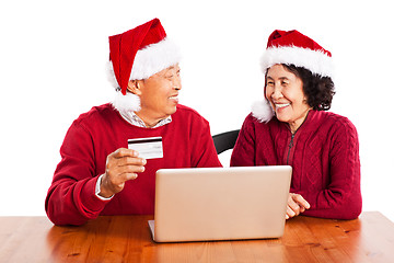 Image showing Senior Asian couple shopping online celebrating Christmas