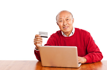 Image showing Senior Asian man shopping online celebrating Christmas