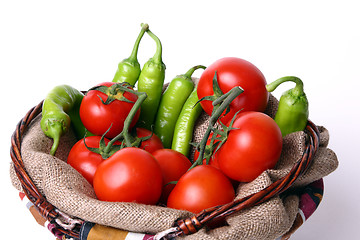 Image showing Basket with red tomatoes and green peperoni