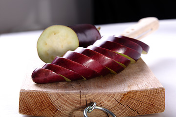 Image showing Eggplant sliced on a wood cutter