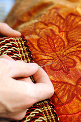 Image showing Craftsman hands working on a curtain