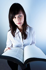 Image showing Confident business woman holding a book