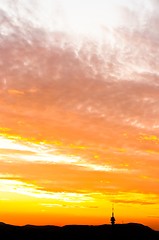 Image showing Sunset with orange clouds and silhouette of the mountains