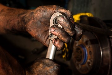 Image showing Hard working man with hands full of oil