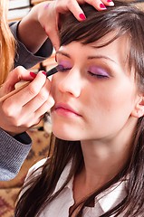 Image showing Beautiful woman getting makeup