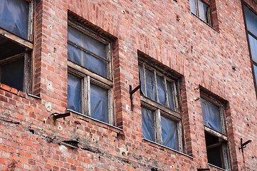 Image showing An abandoned factory wall with broken windows