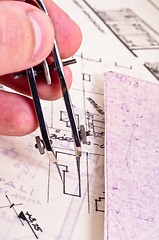 Image showing Fingers of an architect drawing a new home