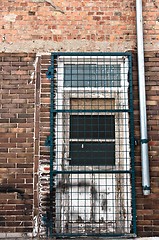 Image showing Door of an abandoned facility with bars