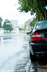 Image showing Closeup shot of a parking car in the rain with blurry background