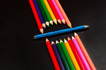 Image showing Monster made out of pencils on black board