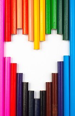 Image showing Colored pencils in heart shape on white