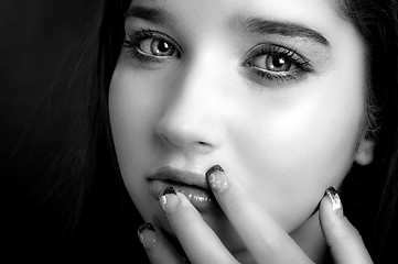 Image showing Young model touching her face with her fingers