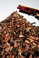 Image showing Firewood piled up with great machines