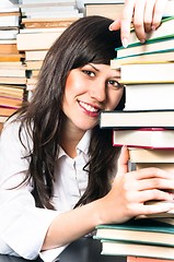 Image showing School girl holding her books and smiling