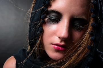 Image showing Girl in black scarf looking down