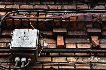 Image showing Electric box on abandoned brick wall