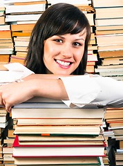 Image showing Cheerful young student and her books