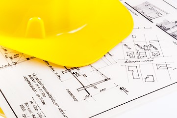 Image showing Construction plans with yellow helmet on it