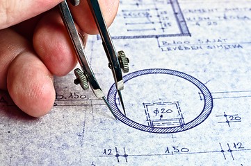 Image showing Fingers of an architect drawing a new home