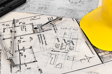 Image showing Angle shot of some construction plans and some accessories