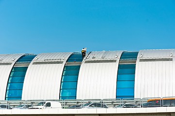 Image showing Two workers finishing the construction on a hot day