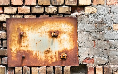 Image showing Abandoned wall texture with metal plate