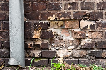 Image showing Brick wall with pipe