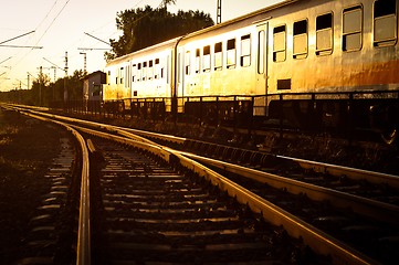 Image showing Train passing by in orange sunset