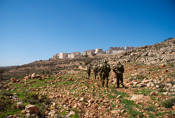 Image showing Israeli soldiers patrol in palestinian village