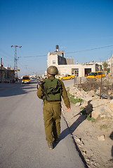 Image showing Israeli soldiers patrol in palestinian village