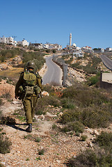 Image showing Israeli soldiers patrol in palestinian village