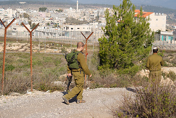 Image showing Israeli soldiers patrol in palestinian village