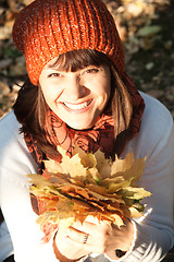 Image showing woman with autumn orange leaves