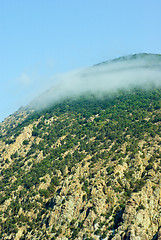 Image showing Small cloud born on the top of cliff