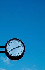 Image showing Clock on blue sky background