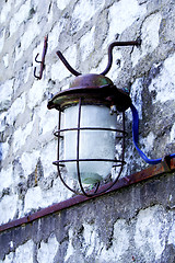 Image showing Street lamp hanging on wall of bricks